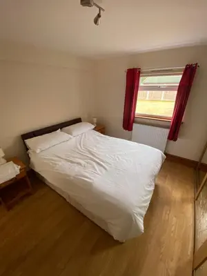 a white bed in a bedroom with a window at Two Bedroom Bungalow No2 - Secure Gated Parking in Basildon