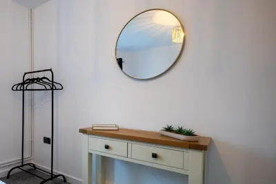 a mirror on the wall above a dresser in a room at Kingfisher in Haverhill