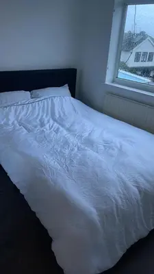 a white bed in a room with a window at The Comfort Suite in Havering atte Bower