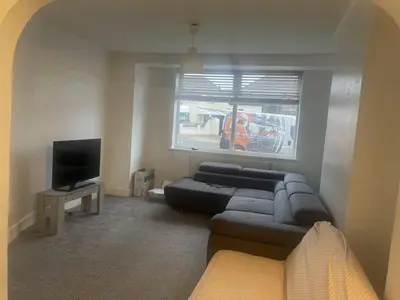 a living room with a couch and a tv at The Comfort Suite in Havering atte Bower