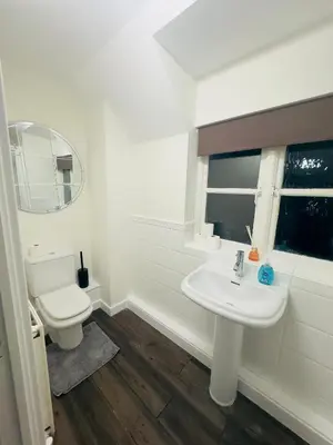 a white bathroom with a toilet and a sink at Comfortable Double Rooms in a Beautiful House in Ipswich