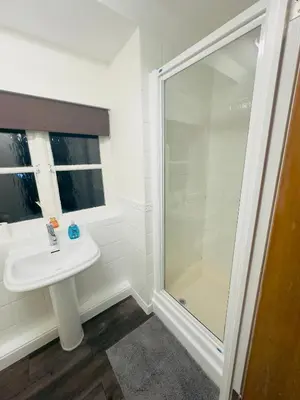 a bathroom with a sink and a shower at Comfortable Double Rooms in a Beautiful House in Ipswich