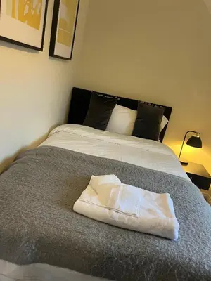 a white towel sitting on top of a bed at Grange Luxe 4 in Martlesham Heath