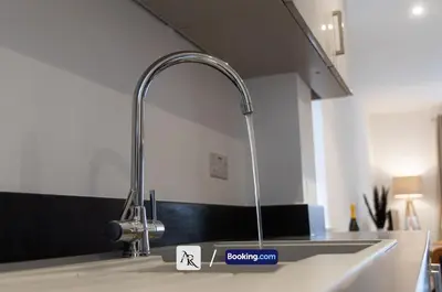 a kitchen sink with a chrome kitchen faucet at Charming 2 BDR House By AR Properties Short Lets & Serviced Accommodation Colchester in Colchester