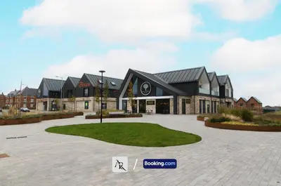 a large building with a green lawn in front of it at Charming 2 BDR House By AR Properties Short Lets & Serviced Accommodation Colchester in Colchester