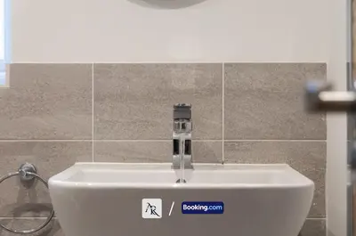 a white sink in a bathroom with a faucet at Charming 2 BDR House By AR Properties Short Lets & Serviced Accommodation Colchester in Colchester