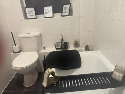 a bathroom with a toilet and a bath tub at Newly decorated Cozy home! in Hythe