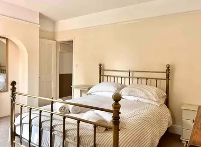 a bedroom with a large bed with white pillows at Tardis Vibes in Stowmarket