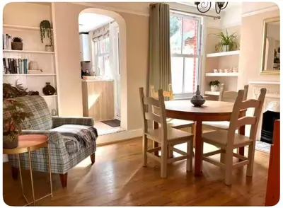 a living room with a table and a couch at Tardis Vibes in Stowmarket