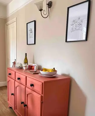 a red cabinet with a bowl of bananas on top of it at Tardis Vibes in Stowmarket