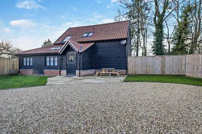 a house with a picnic table and a fence at 2 Bed in Wickhambrook oc-b30507 in Wickhambrook