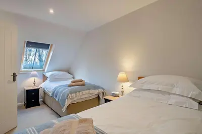 a bedroom with two beds and a window at 2 Bed in Wickhambrook oc-b30507 in Wickhambrook