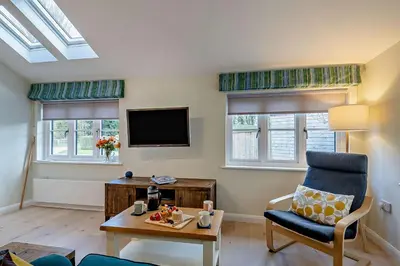 a living room with a chair and a tv at 2 Bed in Wickhambrook oc-b30507 in Wickhambrook
