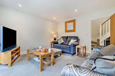 a living room with a couch and a tv at 3 Bed in Framlingham oc-f30353 in Framlingham
