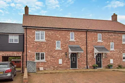a brick house with a car parked in front of it at 3 Bed in Framlingham oc-f30353 in Framlingham