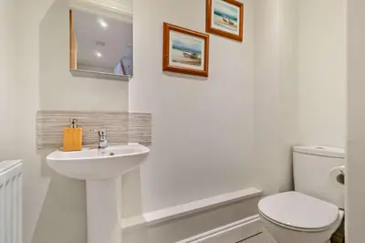 a white bathroom with a toilet and a sink at 3 Bed in Framlingham oc-f30353 in Framlingham