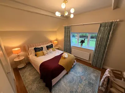 a bedroom with a bed and a window at The Old Coach House in Hockwold cum Wilton