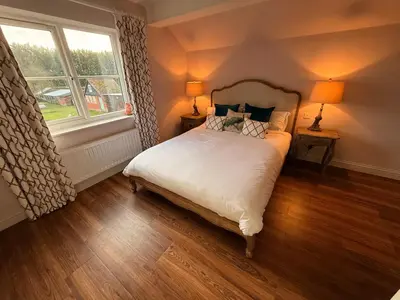 a bedroom with a bed and a window at The Old Coach House in Hockwold cum Wilton