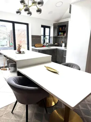 a kitchen with a white table and chairs at Rose home in Haverhill