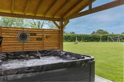 a hot tub under a gazebo in a yard at 4 Bed in Saham Toney oc-o30348 in Saham Toney