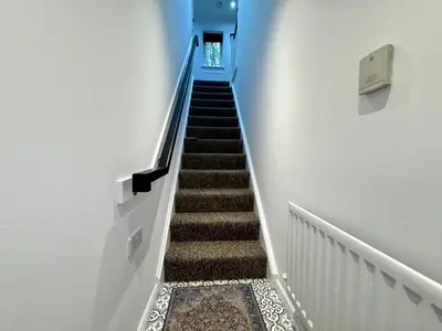 a stairway with a blue and white stair case at A luxurious coach house in Colchester