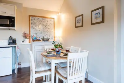 a kitchen and dining room with a table and chairs at Compass Barn, Wenhaston in Wenhaston