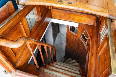 a wooden stairway with a wooden railing and a wooden stair case at Lorna, Houseboat , West Mersea in West Mersea