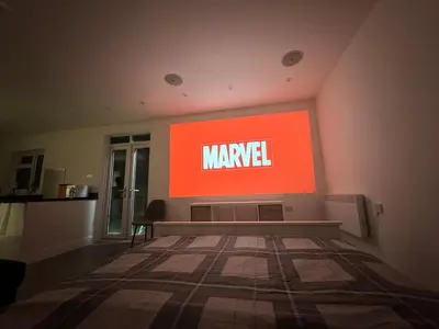 a large sign on a wall with the word marvel at Private cinema studio guest house with garden in Brentwood