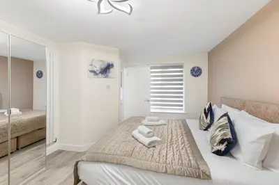 a bedroom with a bed with towels on it at Modern 2 Bed Gem Southend on Sea Free parking in Southend-on-Sea