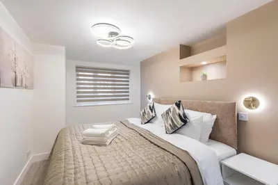 a bedroom with a large bed and a window at Modern 2 Bed Gem Southend on Sea Free parking in Southend-on-Sea