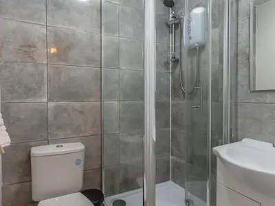 a bathroom with a shower with a toilet and a sink at Studio flat in Heart of Southend - Pass the Keys in Southend-on-Sea