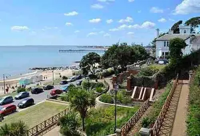 a view of a beach with cars parked in a parking lot at Modern 2 Bedroom Apartment with Sea view in Felixstowe