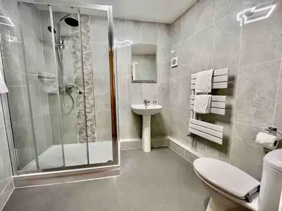 a bathroom with a shower and a toilet and a sink at Modern 2 Bedroom Apartment with Sea view in Felixstowe
