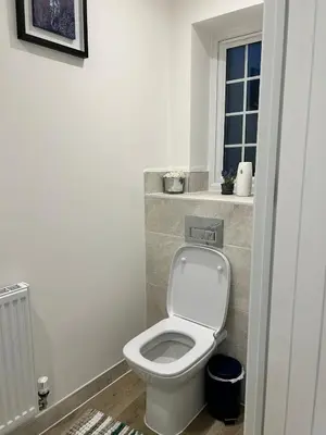a bathroom with a white toilet and a window at The Belles' Place near Colchester in Earls Colne