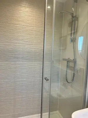 a shower with a glass door in a bathroom at The Belles' Place near Colchester in Earls Colne