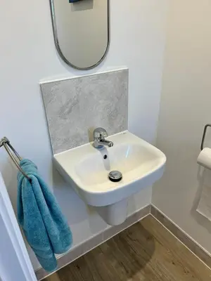 a bathroom with a sink and a mirror at The Belles' Place near Colchester in Earls Colne