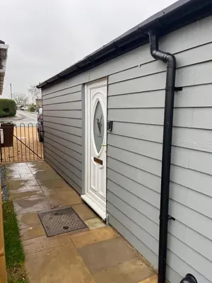 a garage with a door on the side of a house at Brightons view in Saxlingham Thorpe