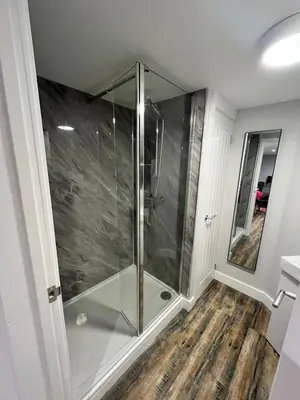 a shower with a glass door in a bathroom at Brightons view in Saxlingham Thorpe