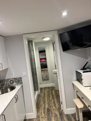 a small kitchen with a sink and a microwave at Brightons view in Saxlingham Thorpe