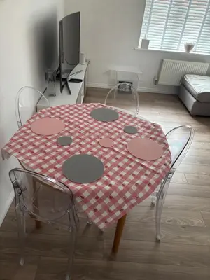 a table with a red and white table cloth on it at Detached Place to stay in Essex in Witham