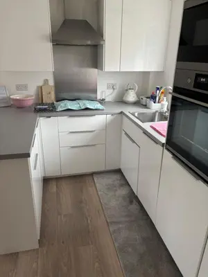 a white kitchen with white cabinets and a sink at Detached Place to stay in Essex in Witham
