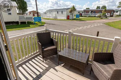two chairs and a table on a porch at Caravan Hire Mersea Island - EOEPS in East Mersea