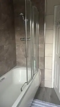 a shower in a bathroom with a white tub at Delightful-Ipswich Suffolk-4 Bed-SelfCatering-Contractor-Parking-Wifi in Copdock