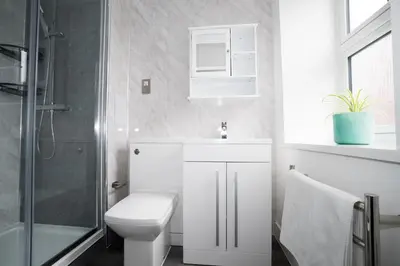 a bathroom with a toilet and a sink and a shower at Ryegate House Colchester in Colchester