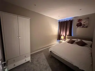 a bedroom with a bed and a dresser in it at 3 bedroom house Colchester in Colchester