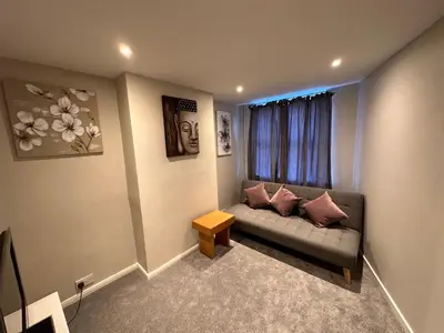 a living room with a couch and a window at 3 bedroom house Colchester in Colchester