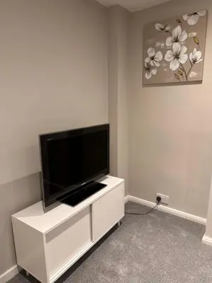 a white entertainment center with a flat screen tv on it at 3 bedroom house Colchester in Colchester