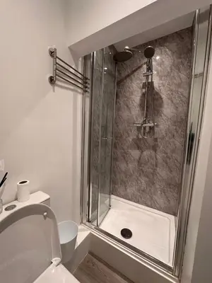 a bathroom with a shower with a toilet at 3 bedroom house Colchester in Colchester