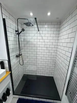 a bathroom with a shower with white tiles at Secret Escape in Cherry Hinton