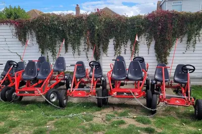 a group of four lawn carts parked in the grass at Highfield Grange Holiday Park in Clacton-on-Sea